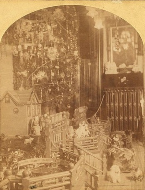 Christmas in America. 19th Century.Christmas tree with toys around, including doll houses, by Roberts & Fellows 2.