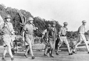 LieutenantGeneral Arthur Percival led by a Japanese officer walks under a flag of truce to negotiate the capitulation of Allied forces in Singapore on 15 February 1942