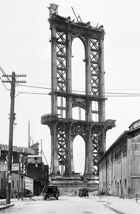 Part of the superstructure of the under-construction Manhattan Bridge rises above Washington Street in New York, on June 5, 1908.